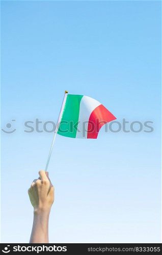 hand holding Italy flag on nature background. National Day, Republic Day, Festa della Repubblica and happy ce≤bration concepts