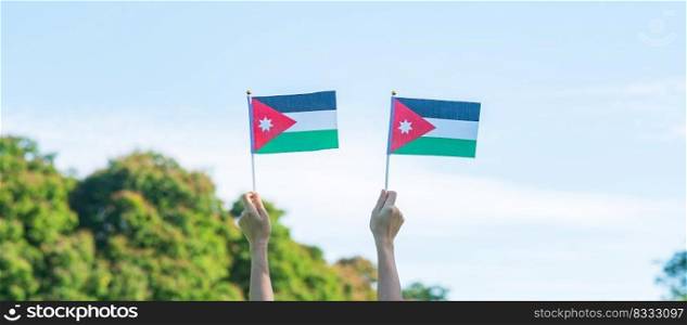 hand holding Jordan flag on nature background. Jordan Independence day and happy celebration concepts