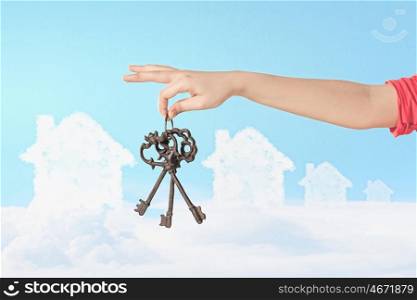Hand holding keys. Close up image of human hand holding keys