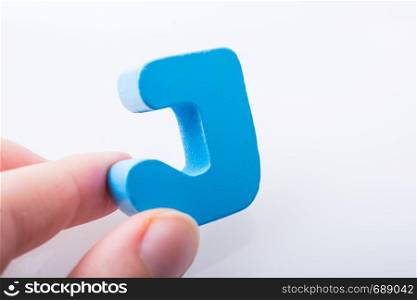 Hand holding Letter cube J of Alphabet
