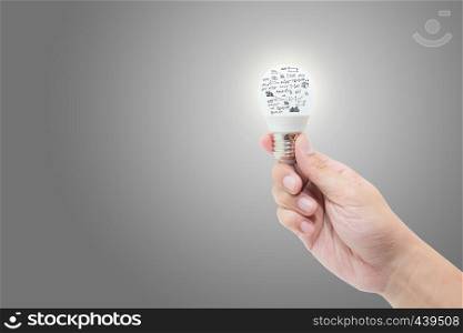 Hand holding light bulb with bright glowing with math formula and graph isolated on white background - solution and success concept.