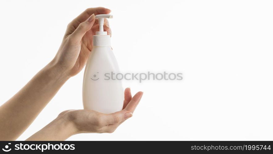 hand holding liquid soap bottle with copy space