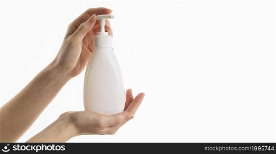 hand holding liquid soap bottle with copy space