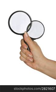 Hand holding magnifying glass on white