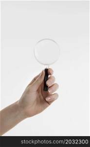 hand holding magnifying glass with copy space