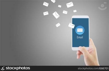 Hand holding man check and sending message with email in a phone on blue background, communication concept.