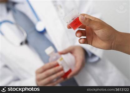 Hand holding medicine in liquid measure