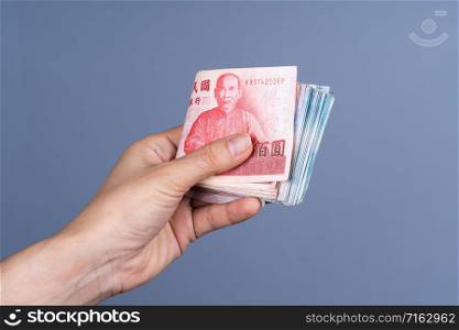 hand holding New Taiwan Dollar banknote, Cash