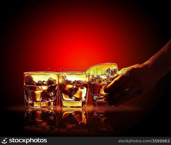 Hand holding one of three glasses of whiskey with nature illustration in