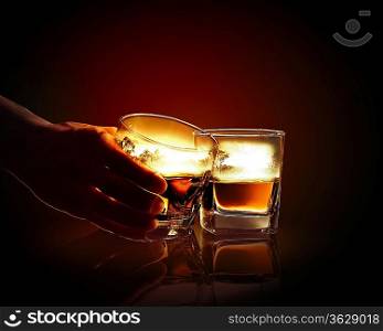 Hand holding one of two glasses of whiskey with nature illustration in