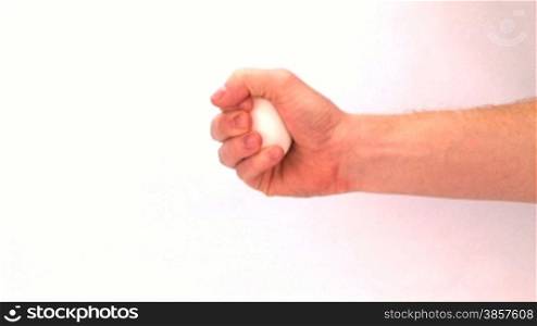 Hand holding out egg over white background, then squeezing until it explodes