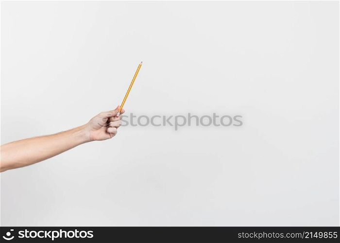 hand holding pencil with copy space background