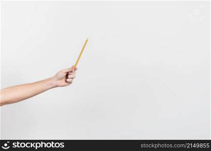 hand holding pencil with copy space background