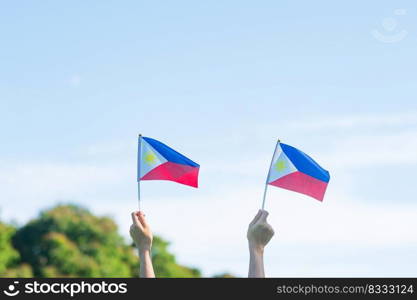 hand holding Philippines flag on nature background. 12th June of Independence day and happy celebration concepts