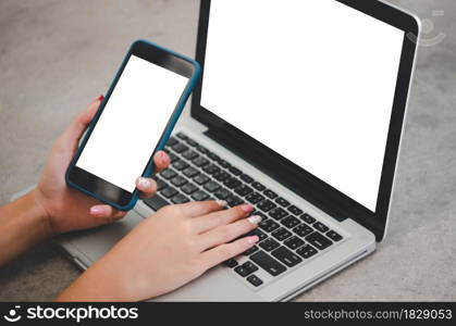 hand holding phone mockup image blank screen computer laptop for advertising text in workplace desk at office.