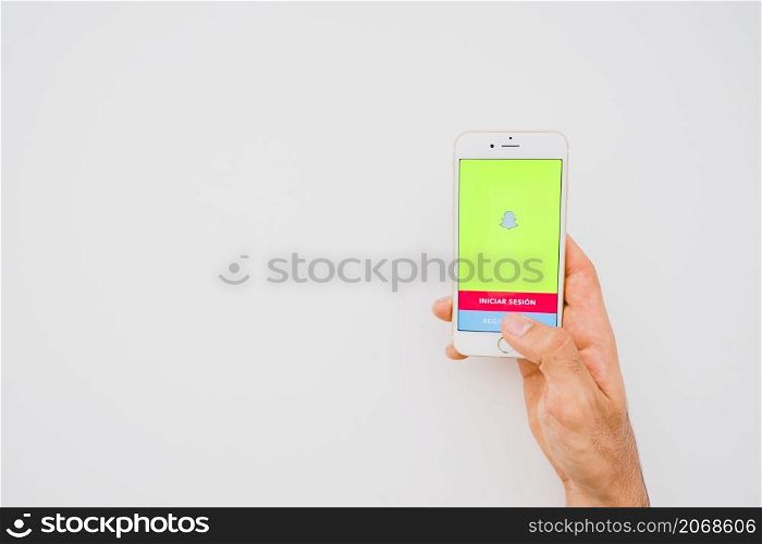 hand holding phone with snapchat copy space