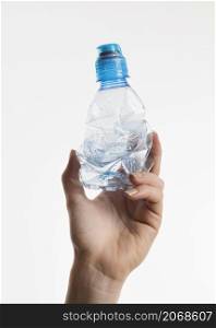 hand holding plastic bottle