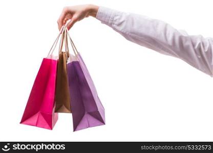 Hand holding shopping bags with christmas shopping on white background. Hand holding shopping bags with christmas shopping on white back