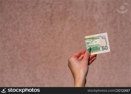 Hand holding showing dollars money and giving or receiving money like tips, salary. 50 USD banknotes, American Dollars currency isolated with copy space.