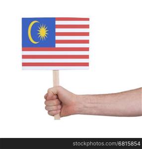 Hand holding small card, isolated on white - Flag of Malaysia