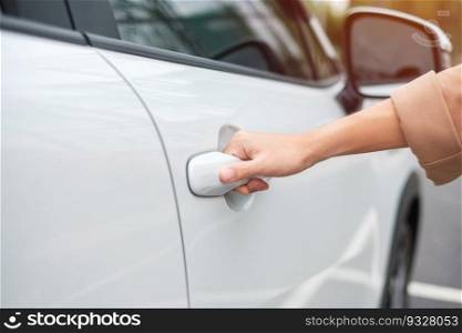Hand holding smart car handle and opening a door. Transport, travel, service and car rental concept