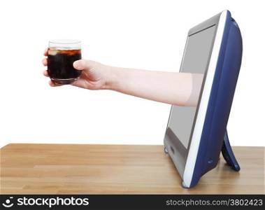 hand holding soft drink with ice in glass leans out TV screen isolated on white background