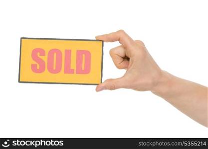 Hand holding sold sign. HQ photo. Not oversharpened. Not oversaturated. Hand holding sold sign isolated