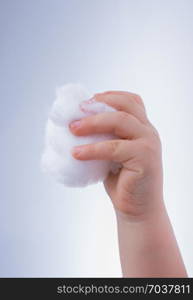 Hand holding some cotton in hand on a white background