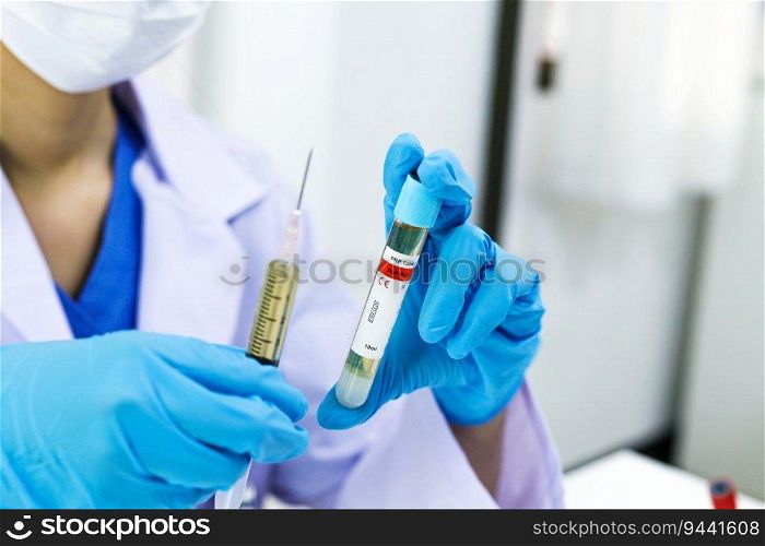 Hand holding syringe and vaccine treatment from Coronavirus covid-19 infection medicine and drug concept
