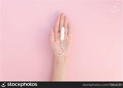 hand holding tampon pink background. High resolution photo. hand holding tampon pink background. High quality photo