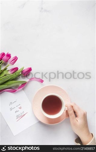 hand holding tea mug copy space
