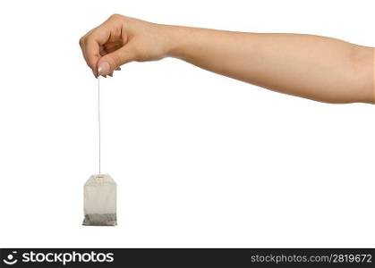 Hand holding teabag on white