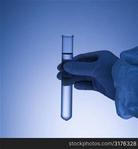 Hand holding test tube.