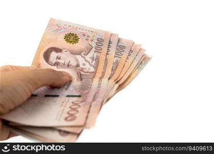 Hand holding Thai currency, 1000 Baht, money banknote of Thailand on white background for business and finance concept