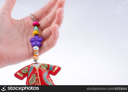 Hand holding traditional clothes with ornaments