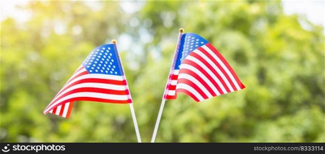 hand holding United States of America flag on green background. USA holiday of Veterans, Memorial, Independence   Fourth of July  and Labor Day concept