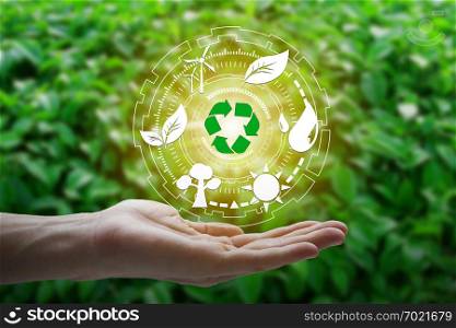 Hand holding with environment Icons over the Network connection on nature background, Technology ecology concept.