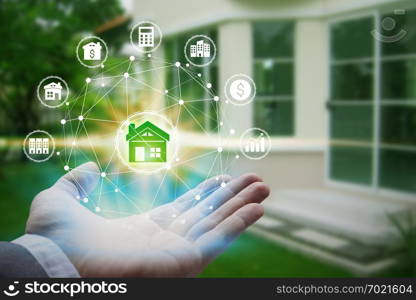 Hand holding with property investment Icons over the Network connection on property background, Property investment concept.