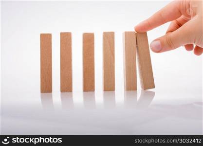 Hand holding wooden domino. Hand holding wooden domino on a white background