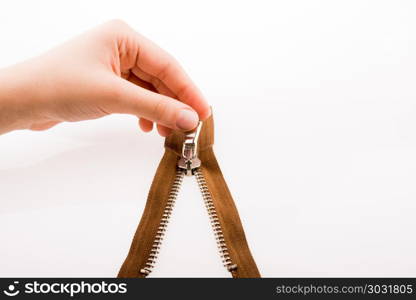 Hand holding zipper. Hand holding color zipper on a white background