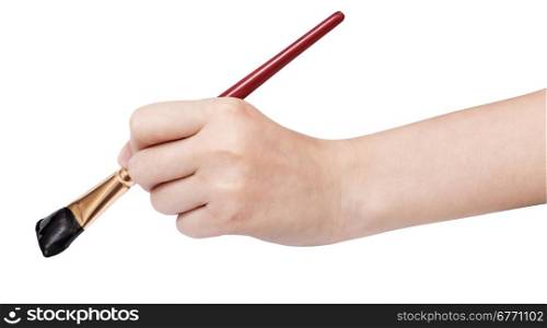 hand holds artistic flat paintbrush with black painted tip isolated on white background