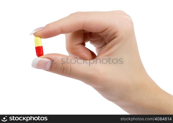 hand holds pill isolated on white
