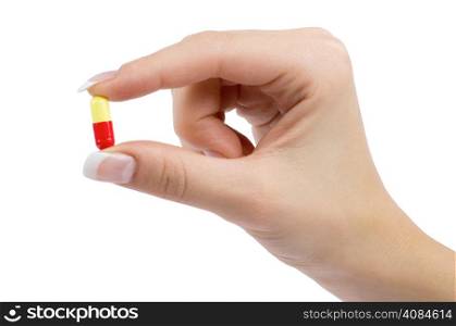 hand holds pill isolated on white