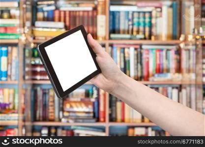 hand holds tablet pc with cut out screen and library on background