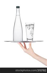 Hand holds tray with bottle and glass of still water on white background