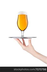 Hand holds tray with lager beer glass with foam and dew isolated on white background