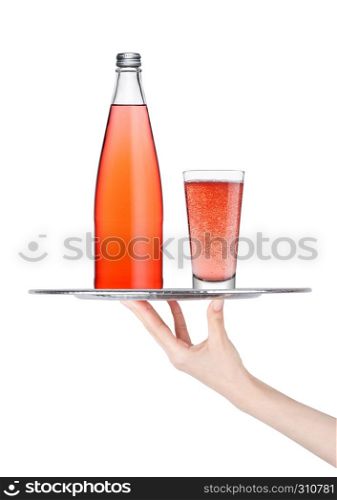 Hand holds tray with pink lemonade soda drink bottle and glass on white background
