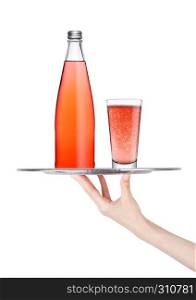 Hand holds tray with pink lemonade soda drink bottle and glass on white background