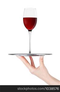 Hand holds tray with red wine glass on white background