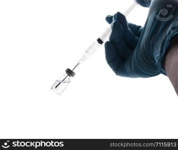 Hand in a blue glove holding syringe isolated on white background